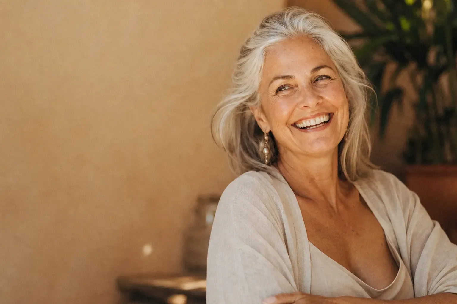 Confident woman in her sixties smiling after a skin rejuvenation consultation at a Lake Havasu City medspa