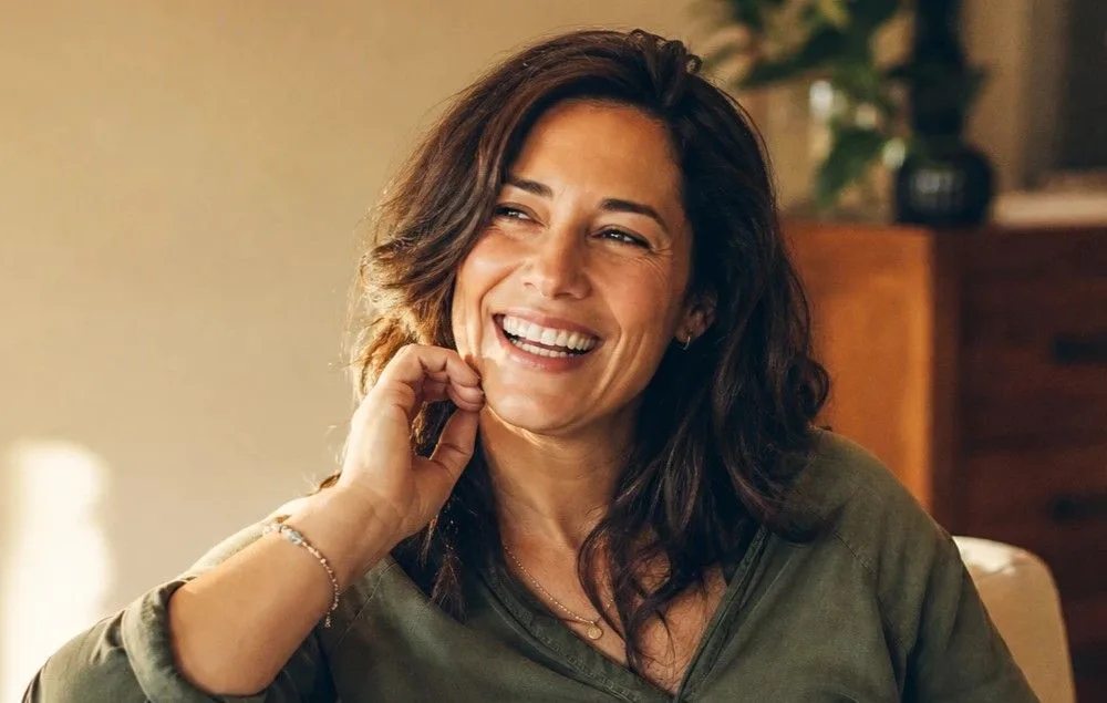 Mother in her thirties relaxed and smiling in soft daylight after non-surgical body and skin treatments in Lake Havasu City