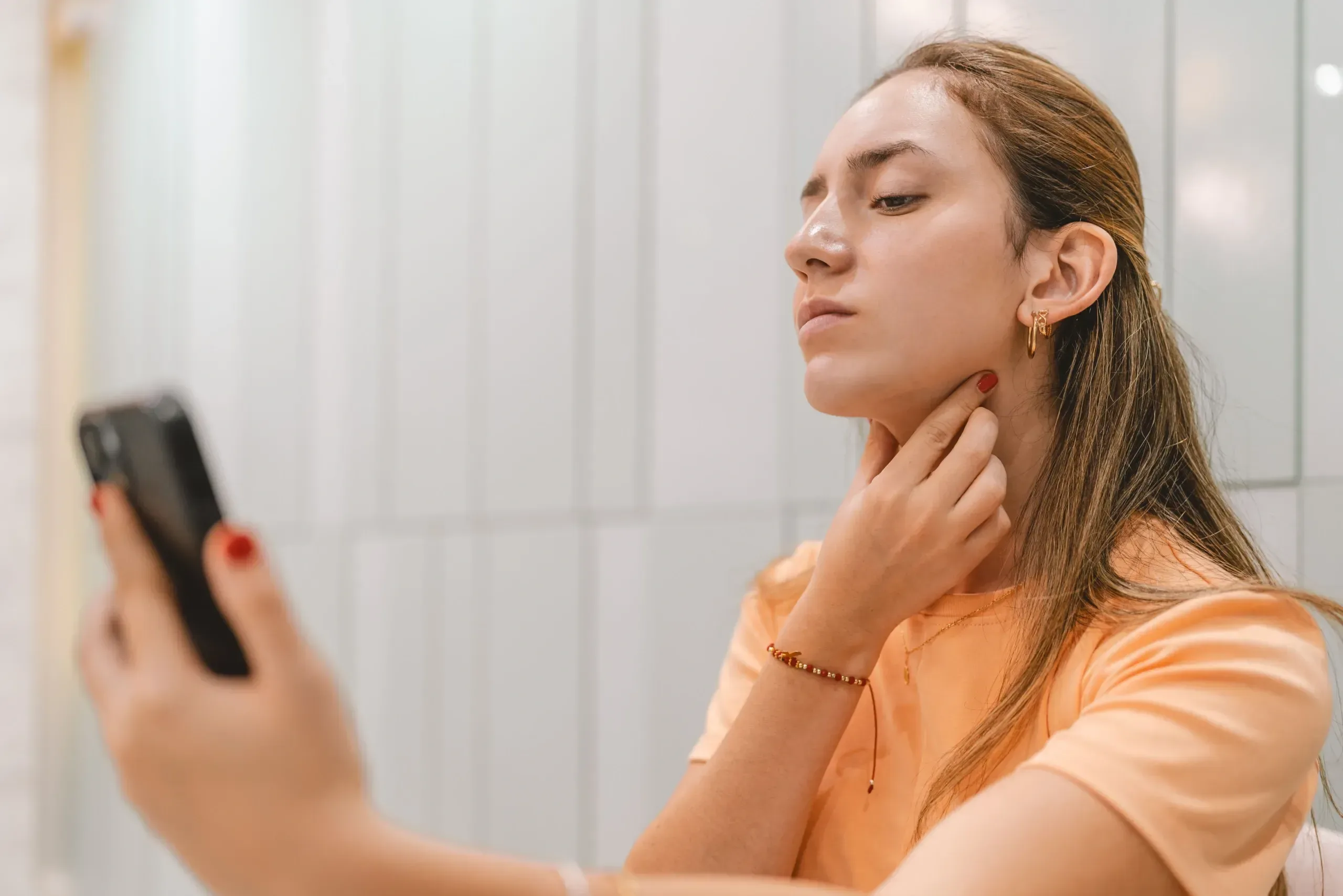 Woman studying her profile and the soft contour under her chin in Lake Havasu City, Arizona