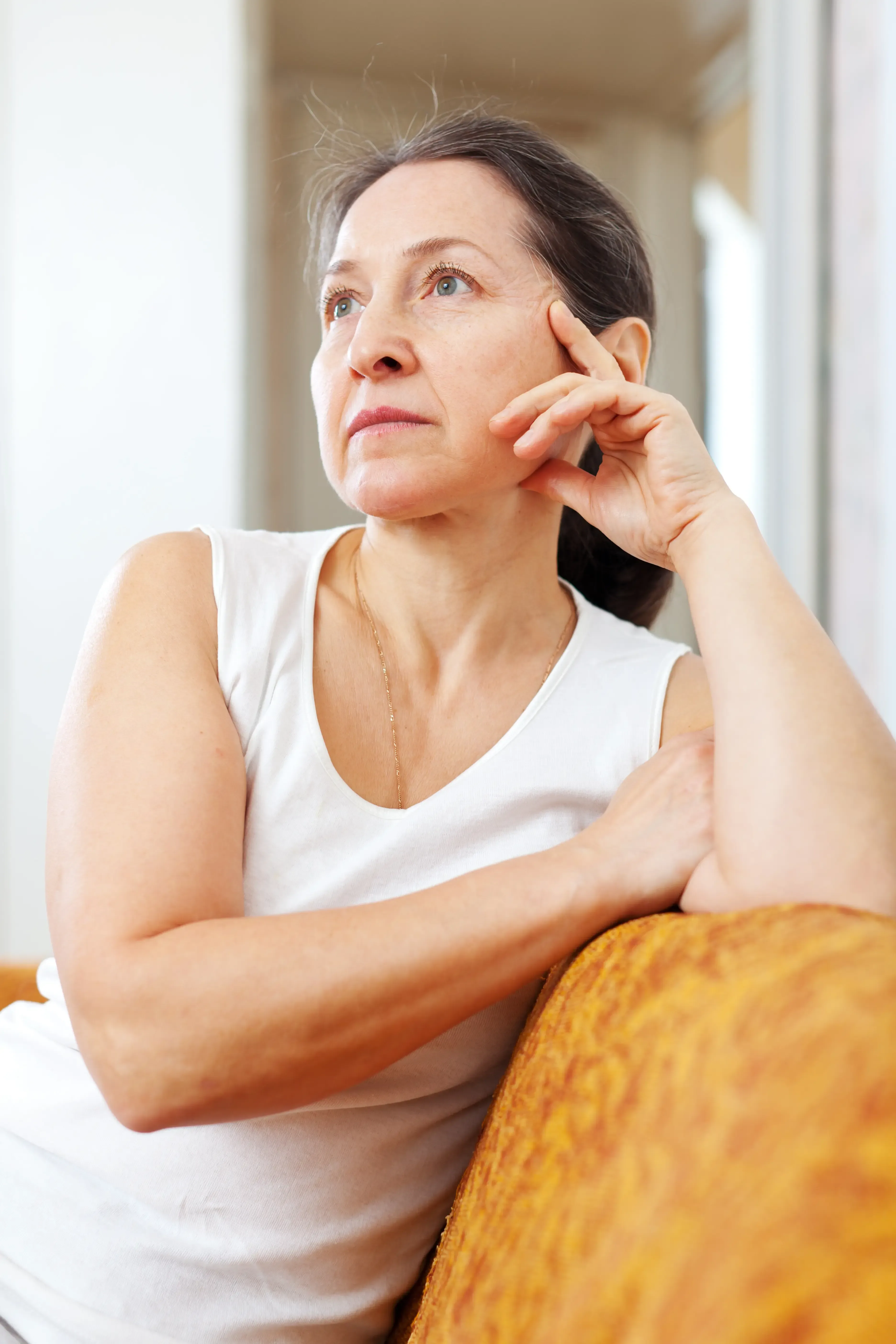 Midlife woman reading about the changes of perimenopause and menopause in a calm home setting