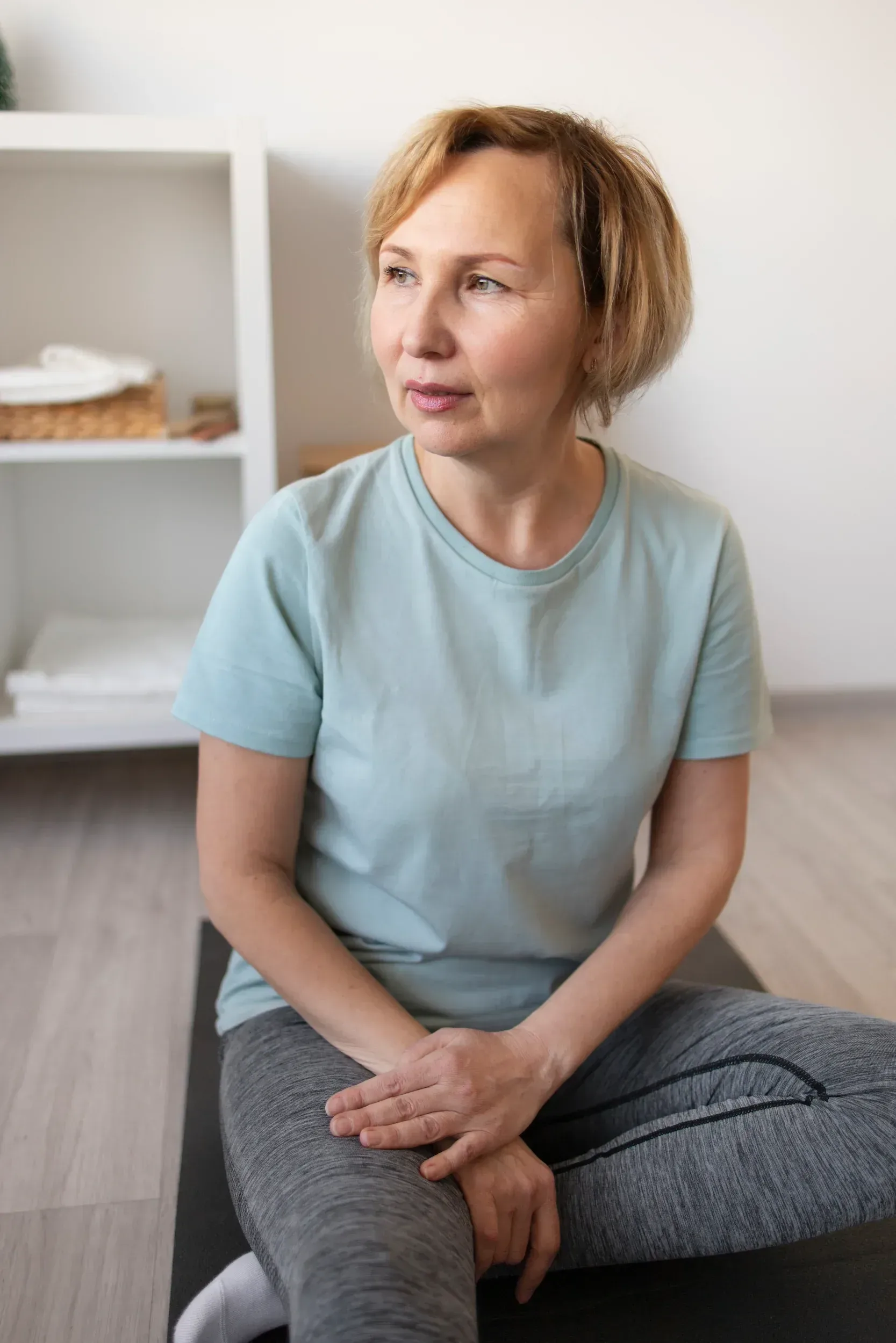 Woman in her sixties sitting calmly in a consultation chair discussing bladder control concerns